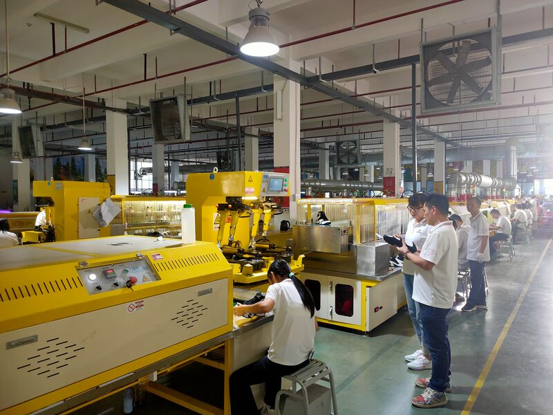 Forming line with yellow machines and operators