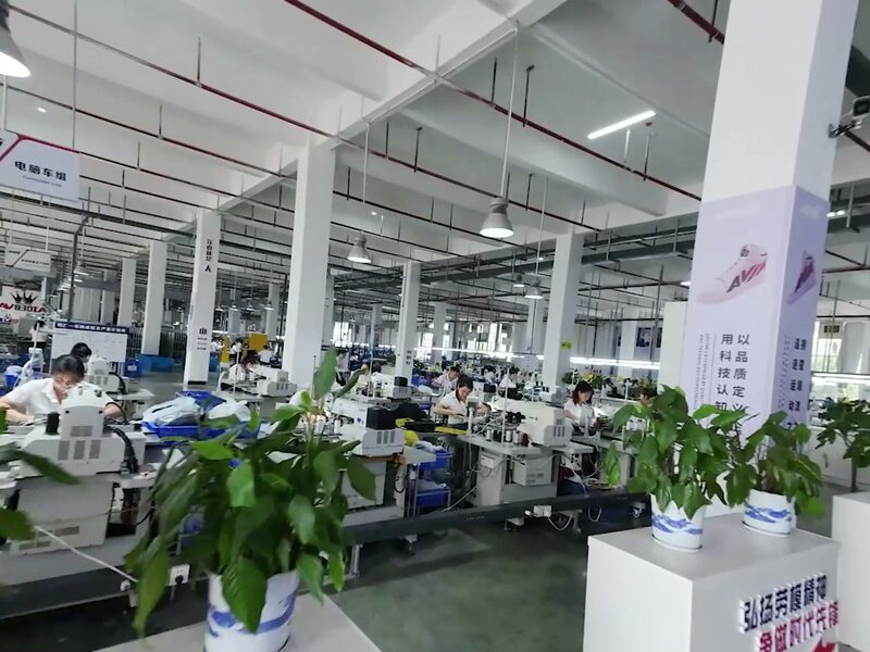 Bright, wide assembly workshop with organised workstations
