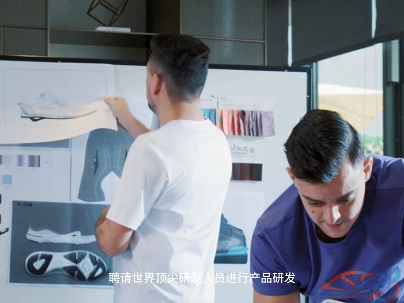 Designers reviewing a technical drawing at a design board