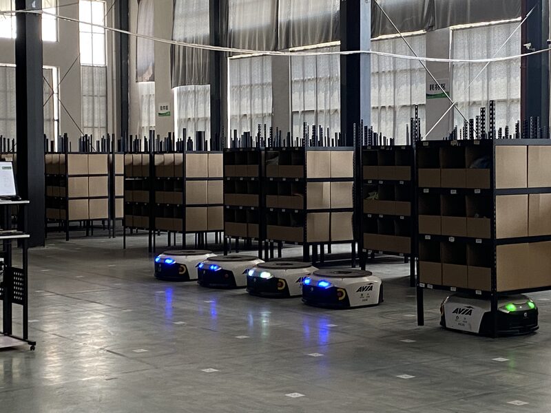Automated guided vehicles moving storage racks in the warehouse