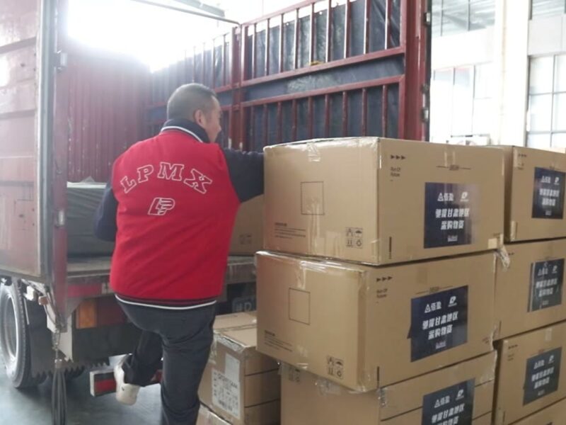 Workers loading cartons into a shipping container