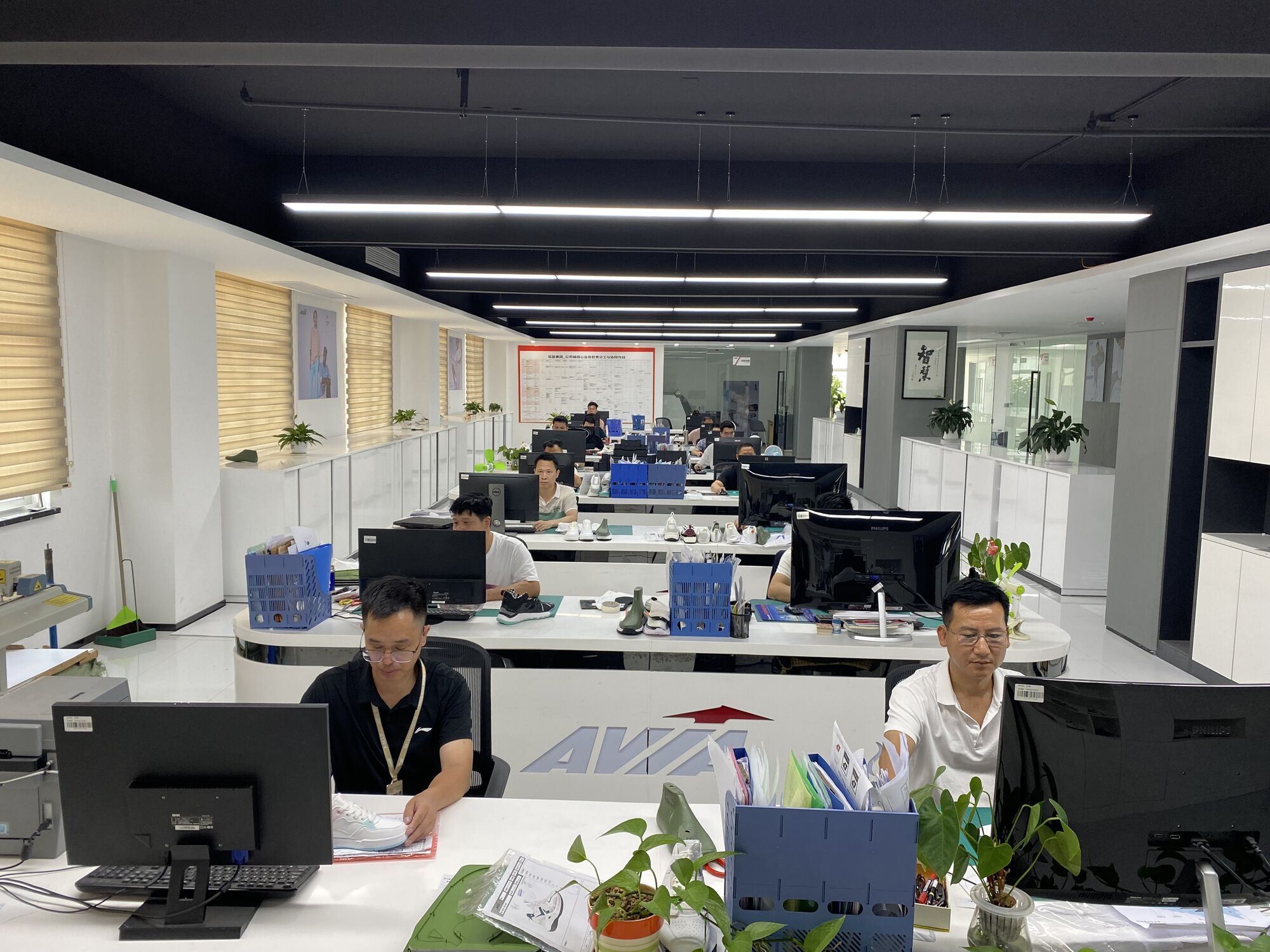 Shoe designers working at the R&D centre where every shoe starts as a tech pack
